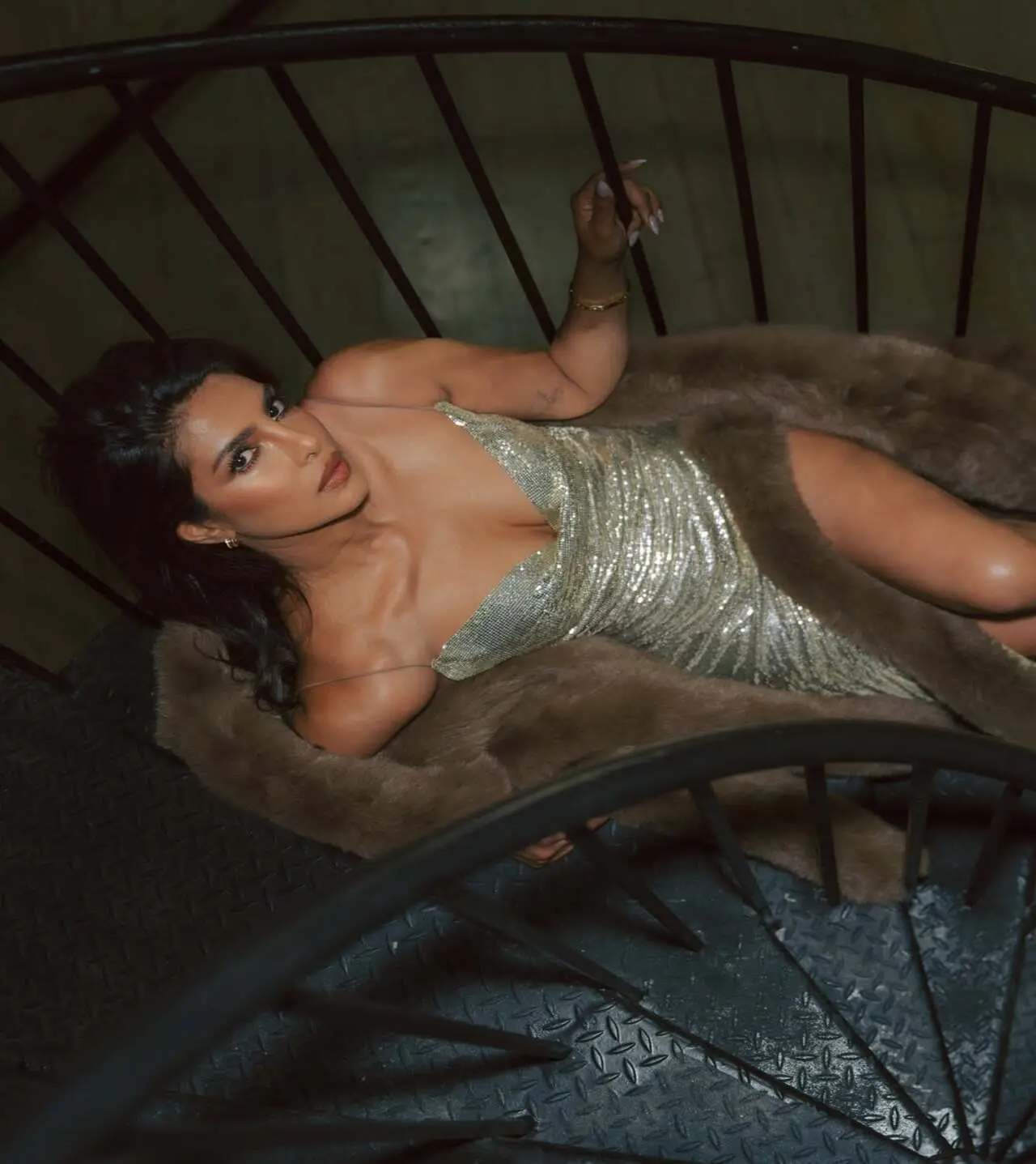 The actress strikes a sultry and sizzling pose, laying down on the stairs